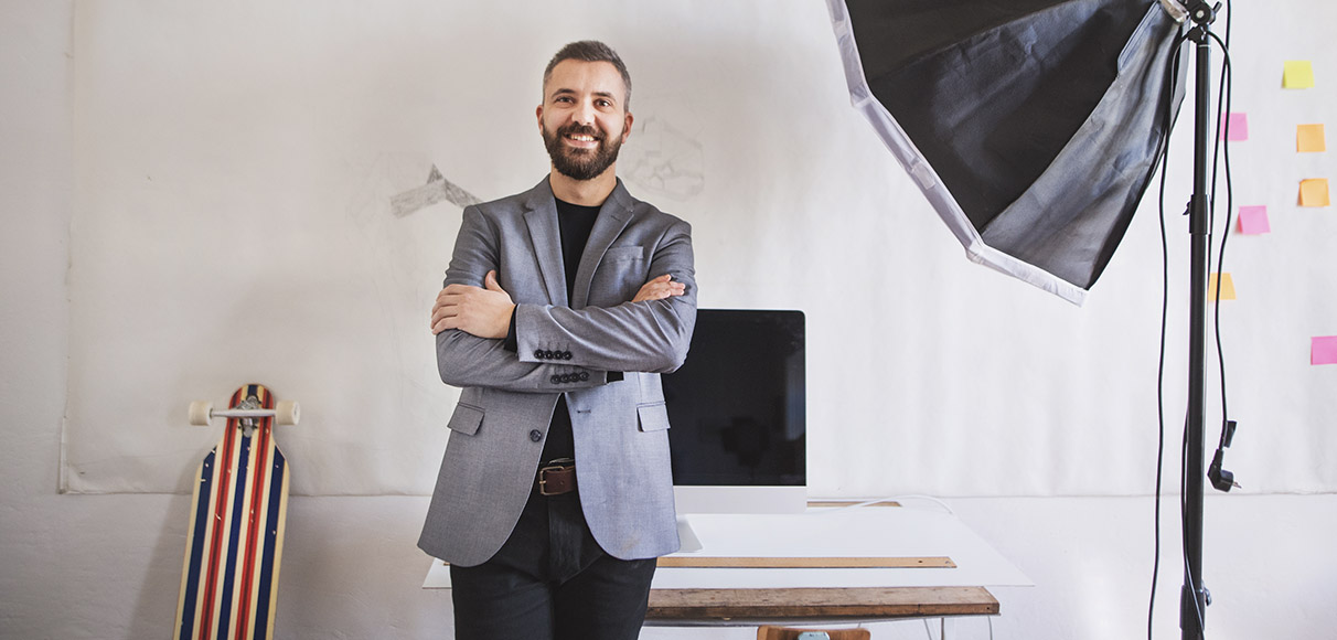 a man in a gray suit posing