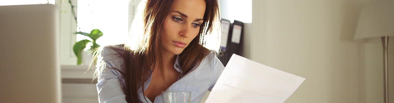 a woman looking over a document